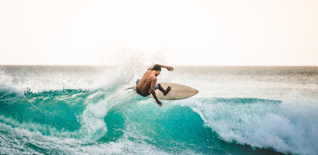 Professional,Surfer,Riding,Waves,In,Bali,,Indonesia.,Men,Catching,Waves
